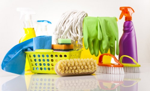 Professional applying carpet cleaning chemicals with protective equipment