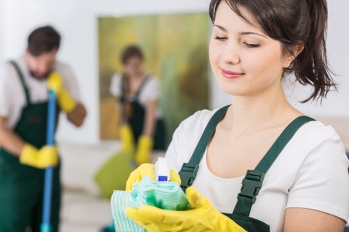Local cleaner working on windows in Fulham near residential flats
