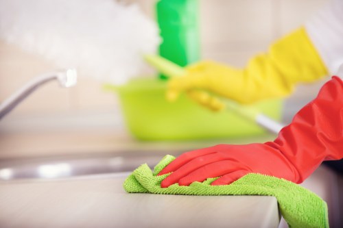 Professional cleaner preparing a guest-ready bedroom in Fulham
